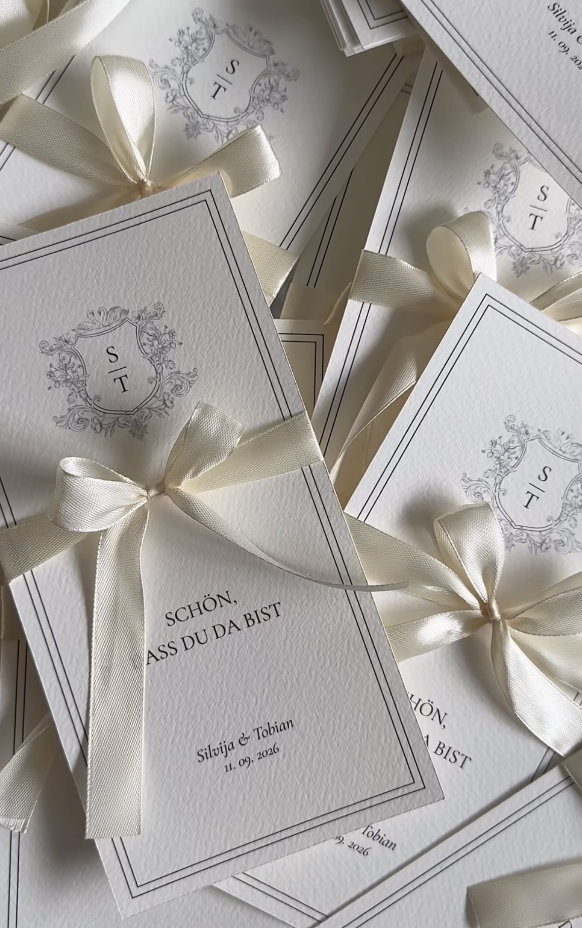 Ivory place cards tied with satin ribbon
